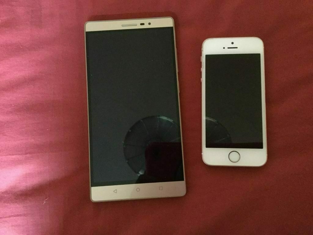 Two mobile phone handsets side by side. Lenovo PHAB2 on the left, iPhone SE on the right.